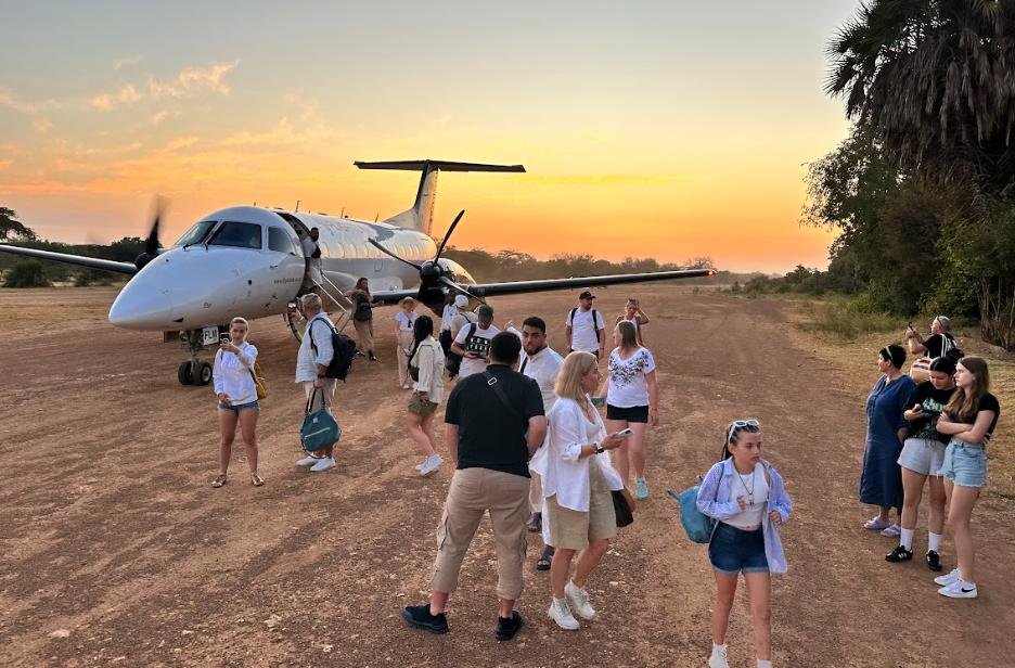 Evening Return Flight to Zanzibar – Mikumi Safari - LITTLE LION TOURS AND SAFARIS Safari Travelers Boarding a Small Aircraft for a Return Flight to Zanzibar