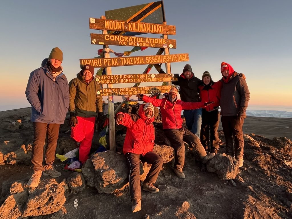 Kilimanjaro-group-summit-scaled (1) - LITTLE LION TOURS AND SAFARIS