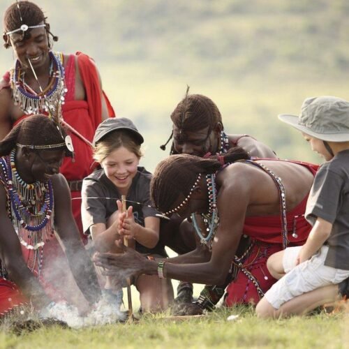 Children learning traditional skills from Maasai people in Tanzania